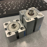 An ultra-compact Festo ADN-S cylinder, left, shows the considerable size reduction compared to a compact ADN cylinder.