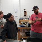 Cutline Purdue Team 15 Jeremy Capstone 2023: Burling Valve Production Manager Jeremy Carpenter (right) explains an internal part of a Burling regulator to Purdue Polytechnic Institute Team 15 members Hunter Kepner (left) and Ray Kurniawan (center). The team is working on improving the superheated steam capabilities of a Burling regulator.